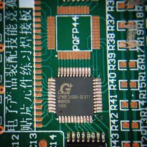 first attempt to solder a QFP part with paste and hot air. doesn’t look too bad.