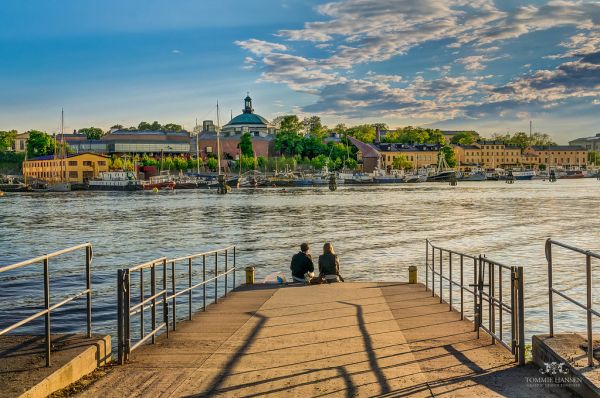 Couple sitting at the docks in Djurgården, Stockholm