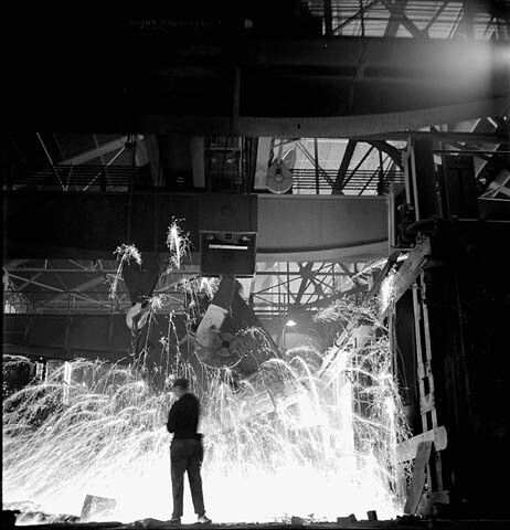 Worker observes ladle pouring molten steel at the Stelco Steel Company of Canada's open-hearth furnaces, Hamilton, Ontar