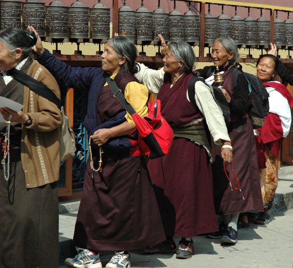 Enlightenment Machine truckin' - happy Tibetan Buddhist women turning prayer wheels, counting prayers on malas, Tharlam 