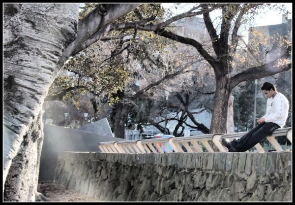 Indian guy sitting & probably waiting for someone