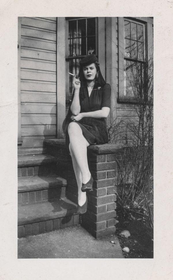 Smoking woman sits on the porch